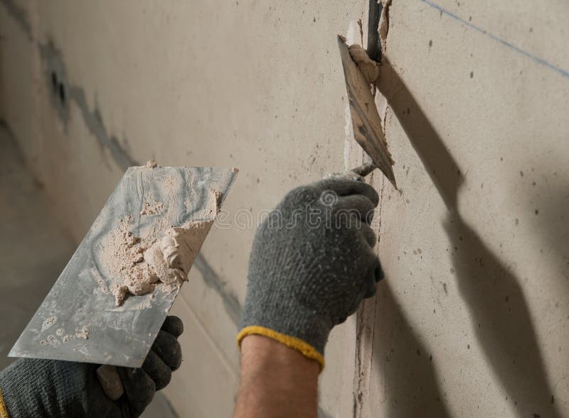 Man fixes a guide to align the walls with stucco in the future. Man fixes a guide to align the walls with stucco in the future