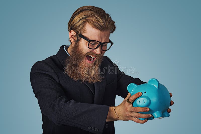 Το άτομο στη piggy τράπεζά του που προσπαθεί το έσπασε επάνω στοκ φωτογραφίες Το άτομο στη piggy τράπεζά του που προσπαθεί το έσπασε επάνω στοκ φωτογραφίες