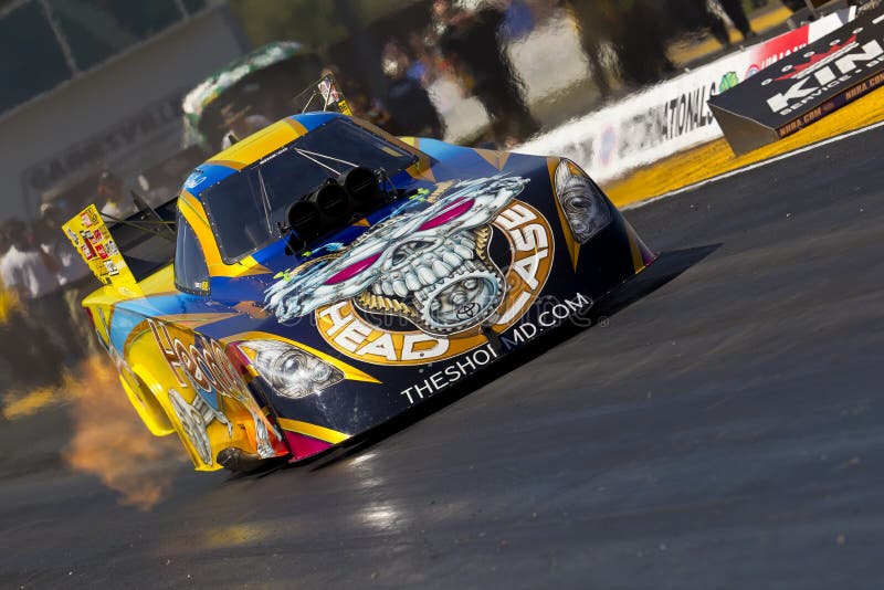 GAINESVILLE, FL - MAR 11, 2011: Driver, Jim Head, brings his Funny Car race car down the track during a qualifying run for the Tire Kingdom NHRA Gatornationals race in Gainesville, FL. GAINESVILLE, FL - MAR 11, 2011: Driver, Jim Head, brings his Funny Car race car down the track during a qualifying run for the Tire Kingdom NHRA Gatornationals race in Gainesville, FL.