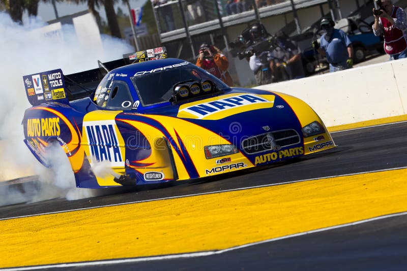 GAINESVILLE, FL - MAR 11, 2011: Driver, Ron Capps, brings his Funny Car race car down the track during a qualifying run for the Tire Kingdom NHRA Gatornationals race in Gainesville, FL. GAINESVILLE, FL - MAR 11, 2011: Driver, Ron Capps, brings his Funny Car race car down the track during a qualifying run for the Tire Kingdom NHRA Gatornationals race in Gainesville, FL.