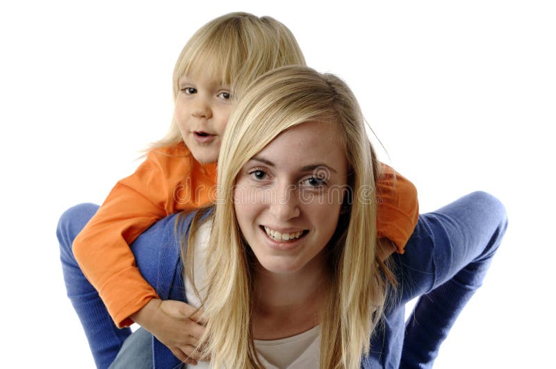 Teenage girl piggybacks a toddler while babysitting. Teenage girl piggybacks a toddler while babysitting.