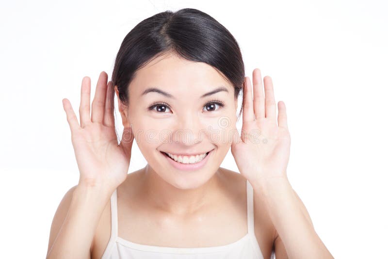 Young Girl listen by ear with smile face isolated on white background, model is a asian woman. Young Girl listen by ear with smile face isolated on white background, model is a asian woman