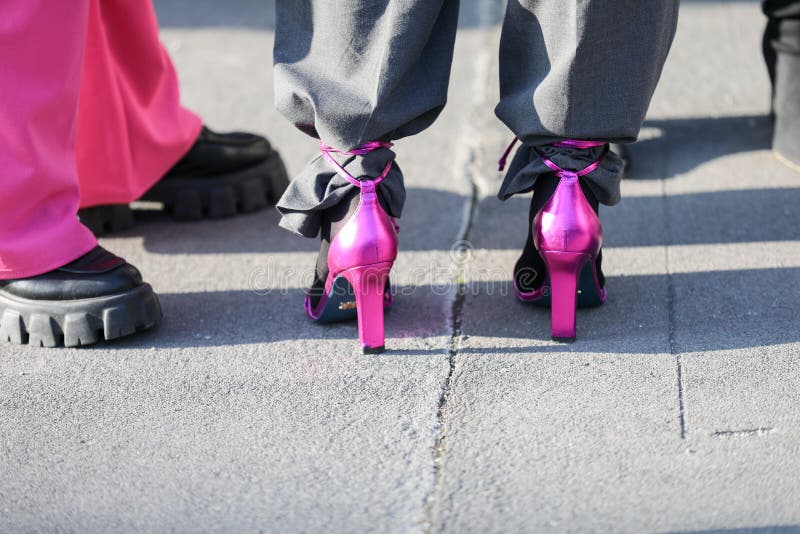 February 19, 2020: model wears a pair of purple shoes with the heel during the Gucci fashion show at the women`s fashion week 2020 in Milan. February 19, 2020: model wears a pair of purple shoes with the heel during the Gucci fashion show at the women`s fashion week 2020 in Milan