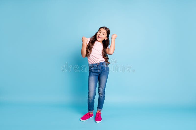 Full length body size view photo content cute kid lucky scream yeah goals, fan free time weekend relax rest raise fists ecstatic reaction funky jeans clothes fuchsia shoes isolated blue background. Full length body size view photo content cute kid lucky scream yeah goals, fan free time weekend relax rest raise fists ecstatic reaction funky jeans clothes fuchsia shoes isolated blue background