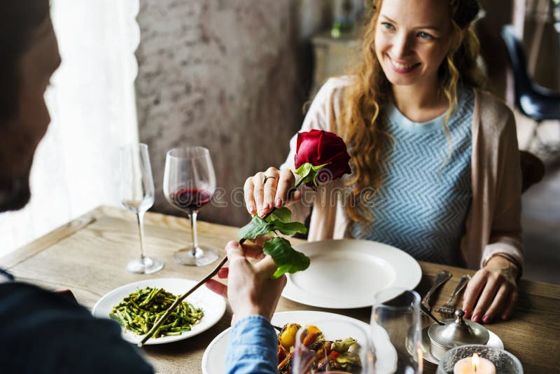 Romantic Man Giving a Rose to Woman on a Date. Romantic Man Giving a Rose to Woman on a Date