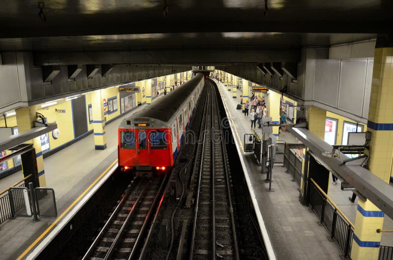 London, England - June 8, 2014: A District Line subway train leaves Aldgate East station platform. The station originally opened in October 1884. The station services nearby areas such as the Whitechapel Art Gallery, Petticoat Lane and Brick Lane. he London Underground (also known as the Tube or simply the Underground) is a public metro system serving a large part of Greater London. The network now has 11 lines and in 2012/13 carried 1.23 billion passengers making it one of the largest and busiest networks in the world. London, England - June 8, 2014: A District Line subway train leaves Aldgate East station platform. The station originally opened in October 1884. The station services nearby areas such as the Whitechapel Art Gallery, Petticoat Lane and Brick Lane. he London Underground (also known as the Tube or simply the Underground) is a public metro system serving a large part of Greater London. The network now has 11 lines and in 2012/13 carried 1.23 billion passengers making it one of the largest and busiest networks in the world.