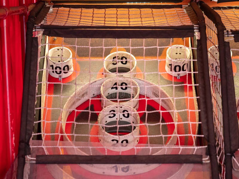 Scoring area of skee ball game behind a net with values of 100 to 10. Scoring area of skee ball game behind a net with values of 100 to 10