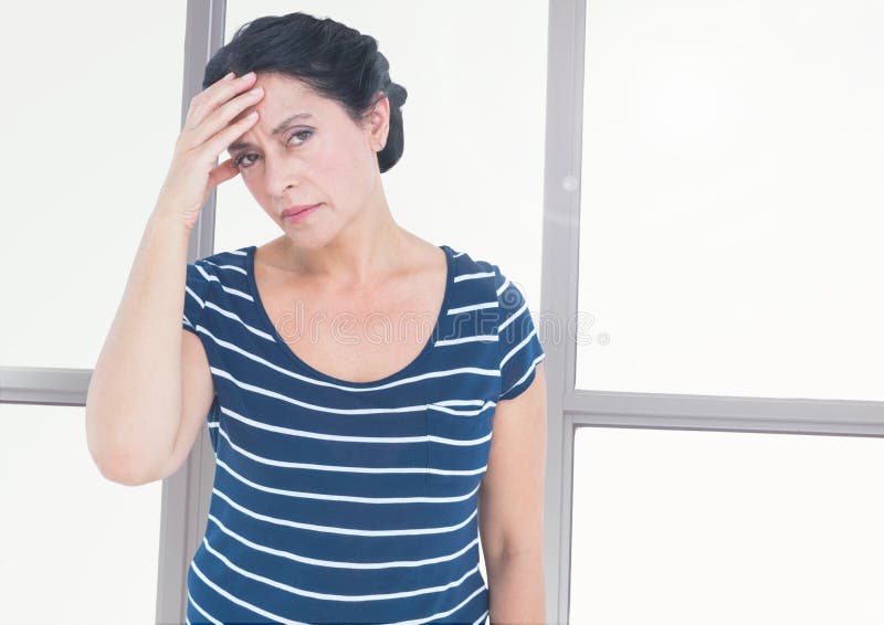 Digital composite of Stressed tired woman in front of windows. Digital composite of Stressed tired woman in front of windows