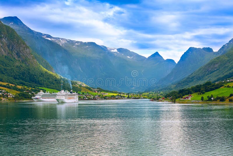 Olden, Norway - August 1, 2018: Norwegian fjord landscape and cruise ships in the port. Olden, Norway - August 1, 2018: Norwegian fjord landscape and cruise ships in the port