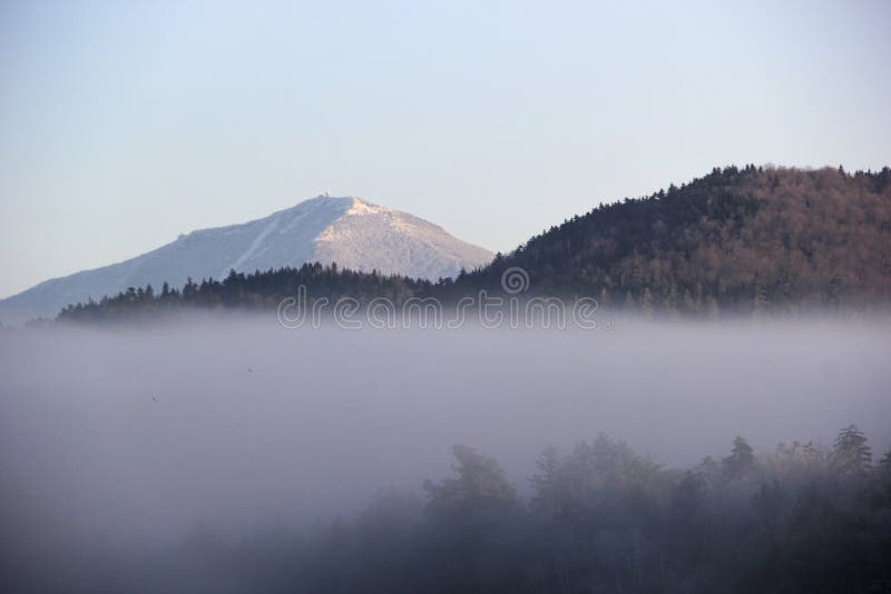 Lake Placid New York, looking over the hill past Mirror Lake at Mount Marcy on a foggy morning. Mt. Marcy the highest point in New York State. Lake Placid New York, looking over the hill past Mirror Lake at Mount Marcy on a foggy morning. Mt. Marcy the highest point in New York State