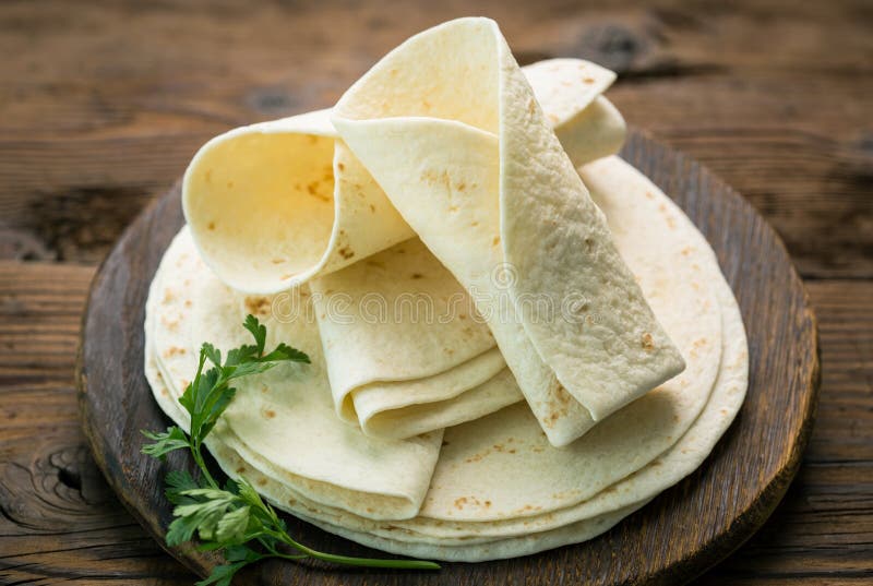 Whole wheat flour tortilla on the wooden table background. Whole wheat flour tortilla on the wooden table background