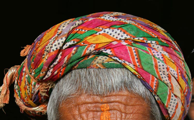 A very colorful Rajasthani turban worn by an old villager in India. A very colorful Rajasthani turban worn by an old villager in India