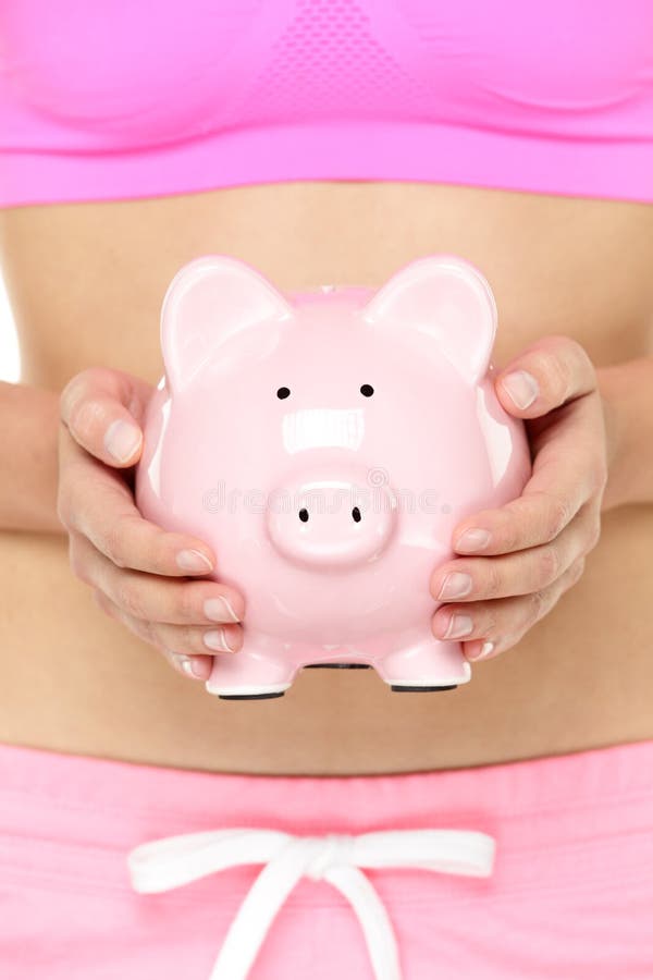 Τράπεζα Piggy μπροστά από το στομάχι στοκ εικόνα Τράπεζα Piggy μπροστά από το στομάχι στοκ εικόνα