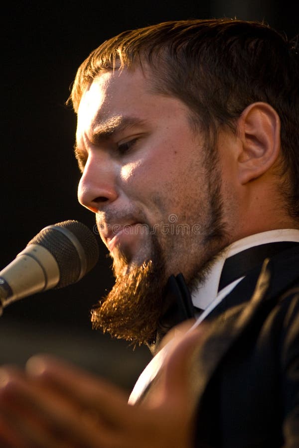 A male opera singer performing on stage. A male opera singer performing on stage.