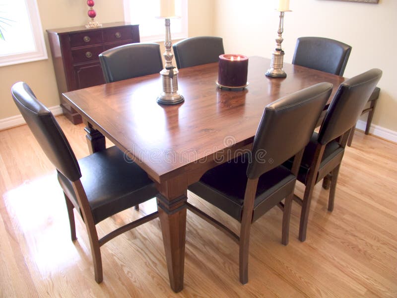 Dining Room with dark wood table, six chairs and two windows with a natural wood floor. Dining Room with dark wood table, six chairs and two windows with a natural wood floor.