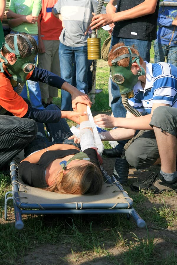 Injured girl, friends treating her injury and on-lookers. Injured girl, friends treating her injury and on-lookers