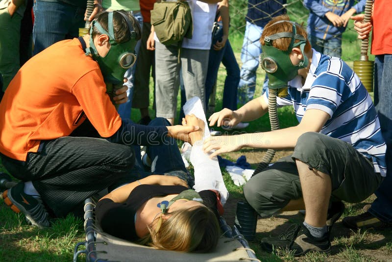 Injured girl, friends treating her injury and on-lookers. Injured girl, friends treating her injury and on-lookers