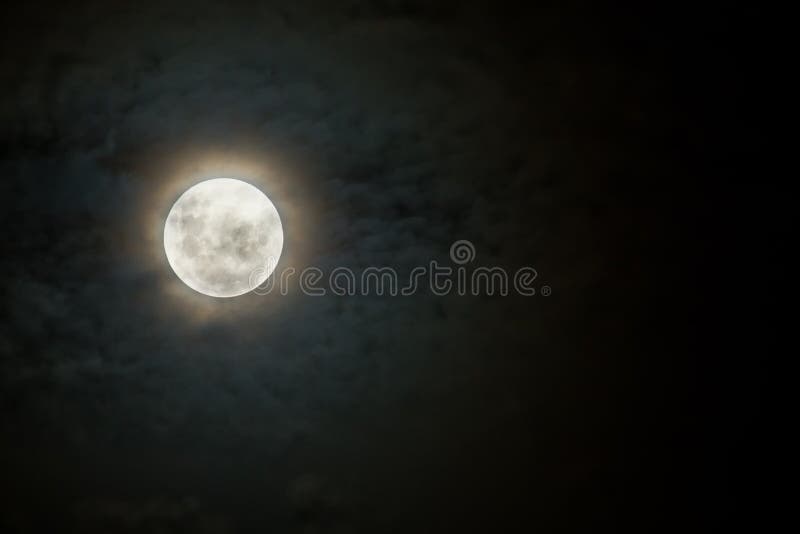 Scary moon on a dark and cloudy night with halo. Scary moon on a dark and cloudy night with halo