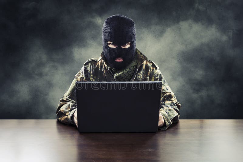 Masked cyber terrorist in military uniform hacking army intelligence. Masked cyber terrorist in military uniform hacking army intelligence