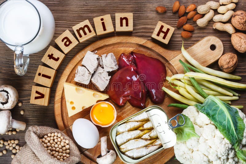 Foods rich in vitamin H Biotin. Foods as liver, eggs yolk, yeast, cheese, sardines, soybeans, milk, cauliflower, green beans, mushrooms, peanuts, walnuts and almonds on wooden table. Foods rich in vitamin H Biotin. Foods as liver, eggs yolk, yeast, cheese, sardines, soybeans, milk, cauliflower, green beans, mushrooms, peanuts, walnuts and almonds on wooden table