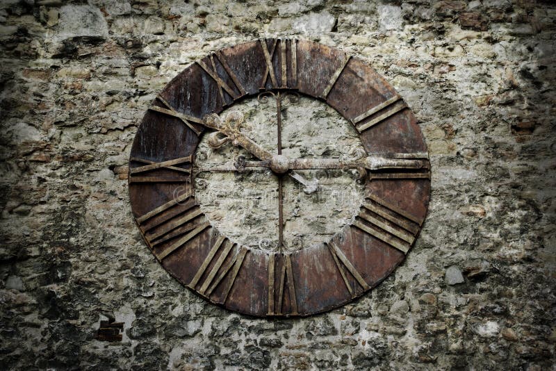 Vintage clock mounted on a stone wall. Vintage clock mounted on a stone wall.