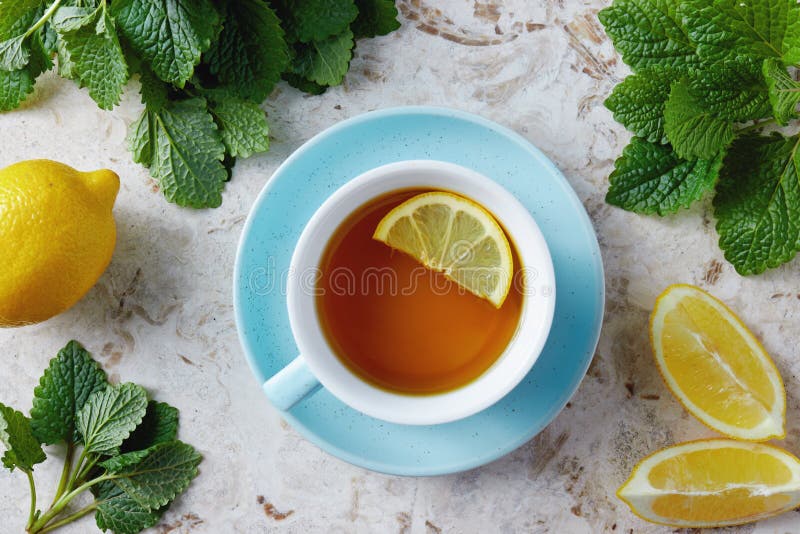 Lemon balm tea with honey. Cup of hot honey lemon balm tea. Lemon balm is a herb that belongs to the mint family and is known for its medicinal benefits. Lemon balm tea with honey. Cup of hot honey lemon balm tea. Lemon balm is a herb that belongs to the mint family and is known for its medicinal benefits.