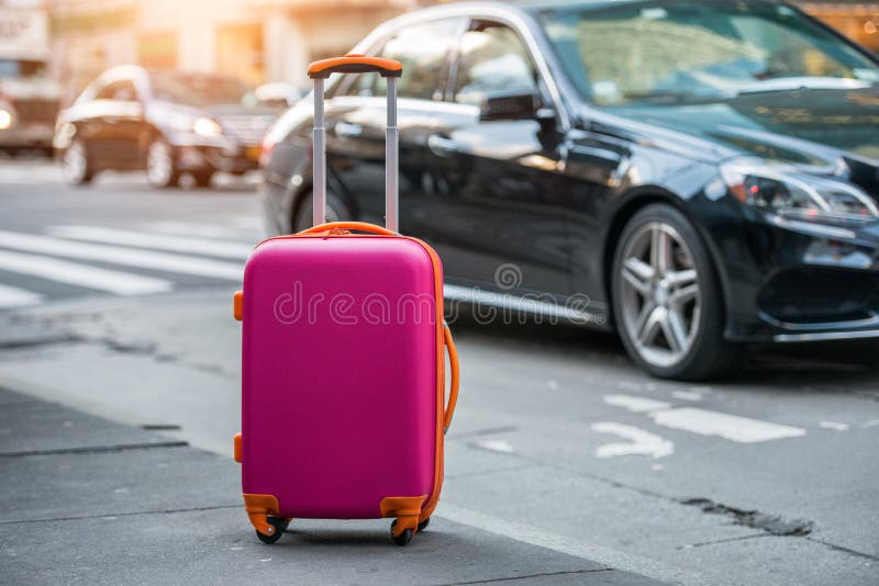 Luggage bag on the city street ready to pick by airport transfer taxi car. Luggage bag on the city street ready to pick by airport transfer taxi car