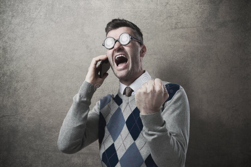 Angry guy yelling at mobile phone with fist raised. Angry guy yelling at mobile phone with fist raised