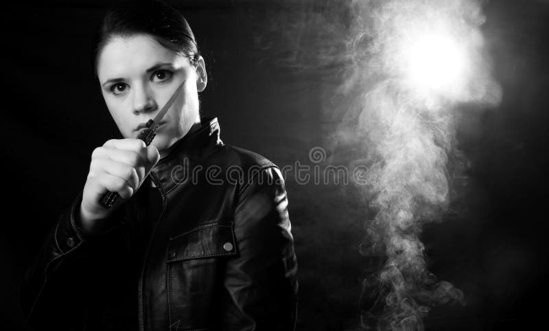 Woman in self defense in a dark smokey place. Woman in self defense in a dark smokey place