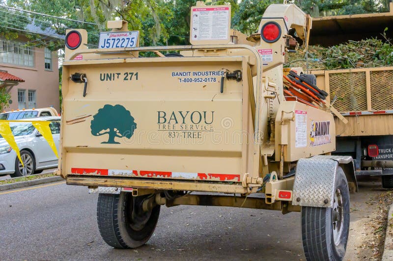 New Orleans, LA, USA - January 11, 2024: Rear of Bayou Tree Service's Bandit Intimidator wood chipper displaying company logo. New Orleans, LA, USA - January 11, 2024: Rear of Bayou Tree Service's Bandit Intimidator wood chipper displaying company logo