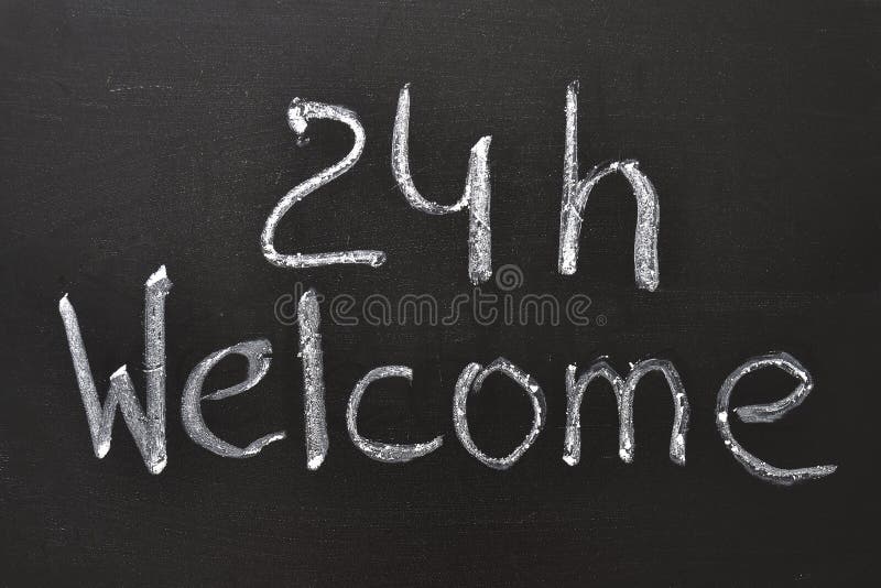 Handwritten 24 h Welcome sign on the blackboard. Handwritten 24 h Welcome sign on the blackboard