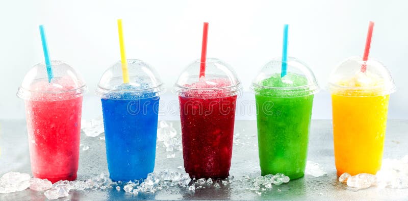 Panoramic Still Life of Colorful Frozen Fruit Slush Granita Drinks in Plastic Take-Away Cups with Lids and Drinking Straws on Cold Metal Surface with Ice. Panoramic Still Life of Colorful Frozen Fruit Slush Granita Drinks in Plastic Take-Away Cups with Lids and Drinking Straws on Cold Metal Surface with Ice