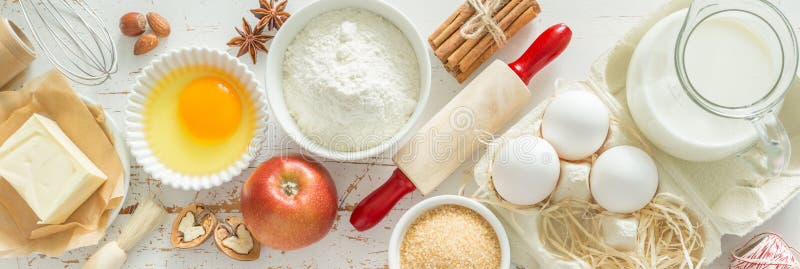 Baking ingredients on rustic background, top view, long format banner. Baking ingredients on rustic background, top view, long format banner