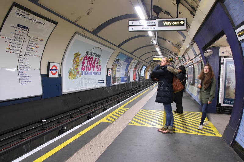 LONDON, UK - MAY 15, 2012: People wait at Camden Town underground station in London. London Underground is the 11th busiest metro system worldwide with 1.1 billion annual rides. LONDON, UK - MAY 15, 2012: People wait at Camden Town underground station in London. London Underground is the 11th busiest metro system worldwide with 1.1 billion annual rides.