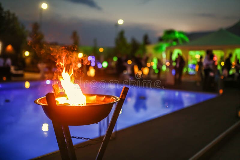 Flaming torch at sunset by the pool. Flaming torch at sunset by the pool