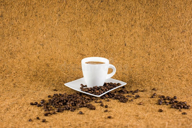 Φλυτζάνι Coffe στην καφετιά σύσταση υποβάθρου στοκ εικόνες Φλυτζάνι Coffe στην καφετιά σύσταση υποβάθρου στοκ εικόνες