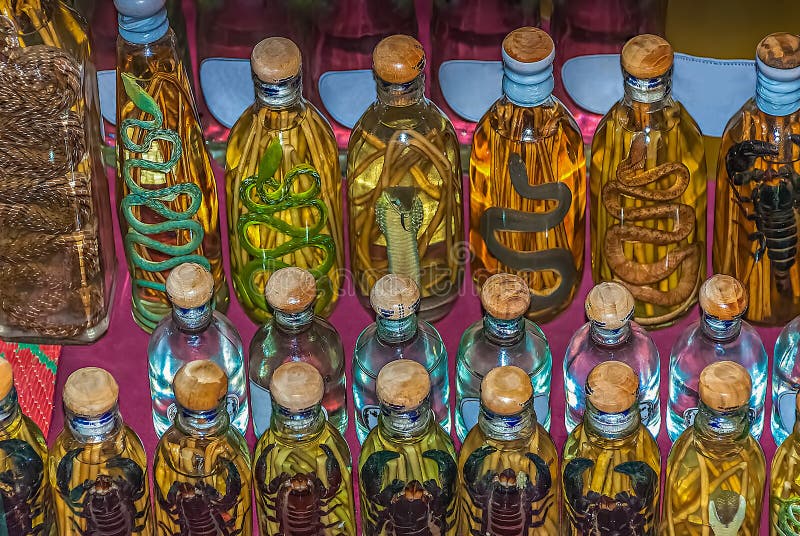 A display of bottles with snakes and scorpions infused in alcohol on sale in a small shop in Luang Prabang, Laos. Certain in alcohol infused animals are considered traditional medicine in Asian culture. A display of bottles with snakes and scorpions infused in alcohol on sale in a small shop in Luang Prabang, Laos. Certain in alcohol infused animals are considered traditional medicine in Asian culture.