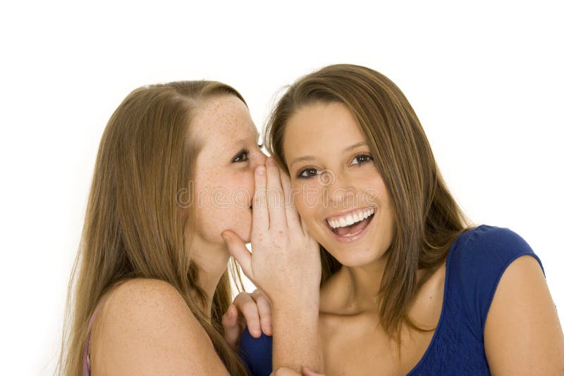 Two beautiful caucasian women telling secret on a white background. Two beautiful caucasian women telling secret on a white background