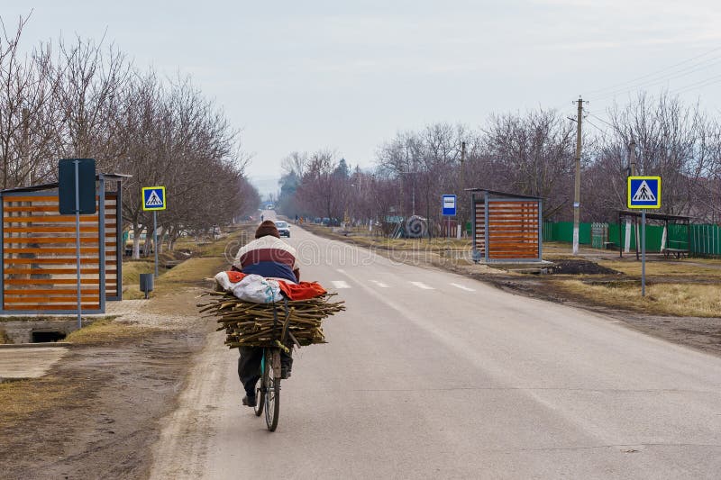 February 1, 2022 Elizavetovka Moldova. A villager on a bicycle carries firewood home to heat his home. The problem of the energy crisis. February 1, 2022 Elizavetovka Moldova. A villager on a bicycle carries firewood home to heat his home. The problem of the energy crisis