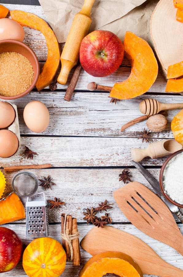 Autumn baking concept. Frame with pumpkin, apple, nuts, cinamon, egg and flour on the wood table. Cooking baking process with ingredients. top view. copy space,. Autumn baking concept. Frame with pumpkin, apple, nuts, cinamon, egg and flour on the wood table. Cooking baking process with ingredients. top view. copy space,