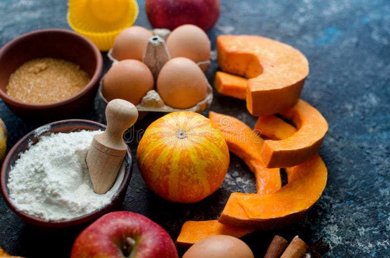 Autumn baking concept. Frame with pumpkin, apple, nuts, cinamon, egg and flour on the wood table. Cooking baking process with ingredients. top view. copy space,. Autumn baking concept. Frame with pumpkin, apple, nuts, cinamon, egg and flour on the wood table. Cooking baking process with ingredients. top view. copy space,