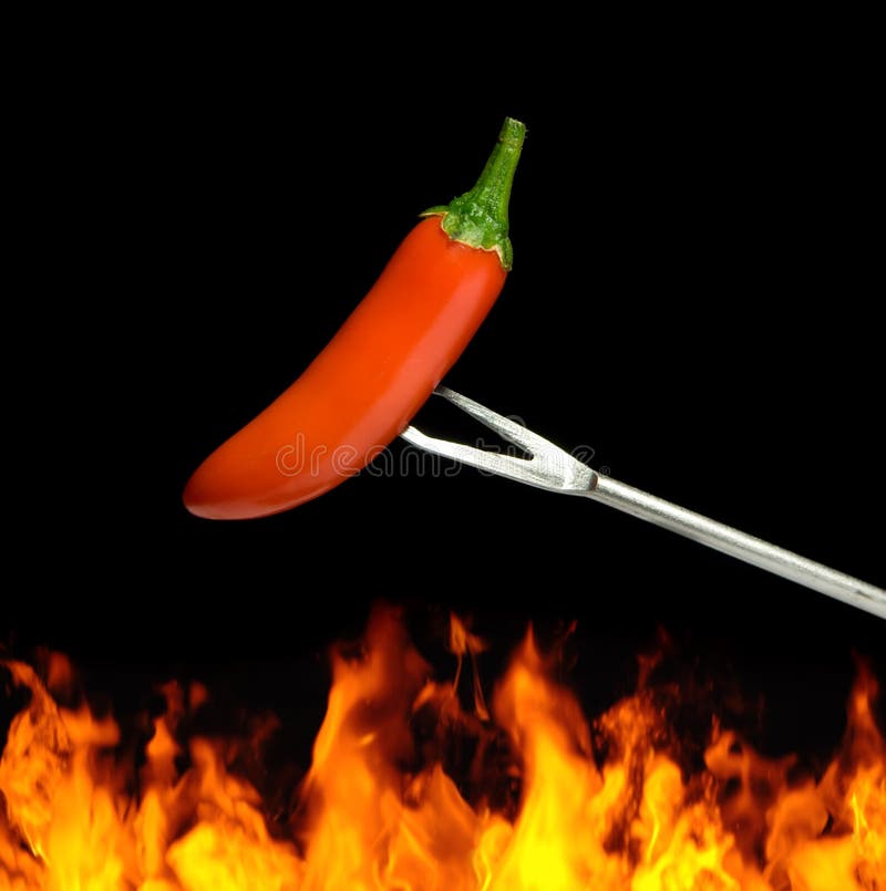 Red chili pepper over flames on a black background. Red chili pepper over flames on a black background