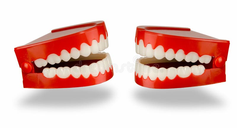 A pair of toy chattering teeth isolated on a white background with a clipping path. A pair of toy chattering teeth isolated on a white background with a clipping path