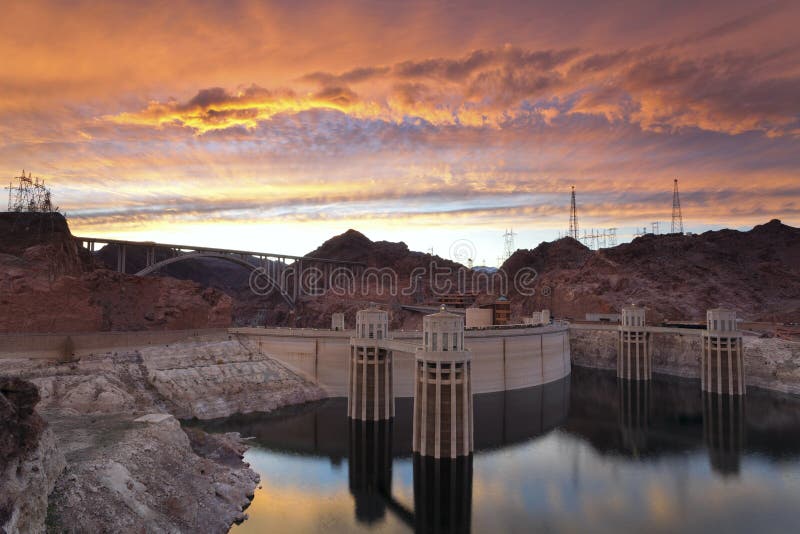 Image of Hoover Dam and bridge during dramatic sunset. Image of Hoover Dam and bridge during dramatic sunset.