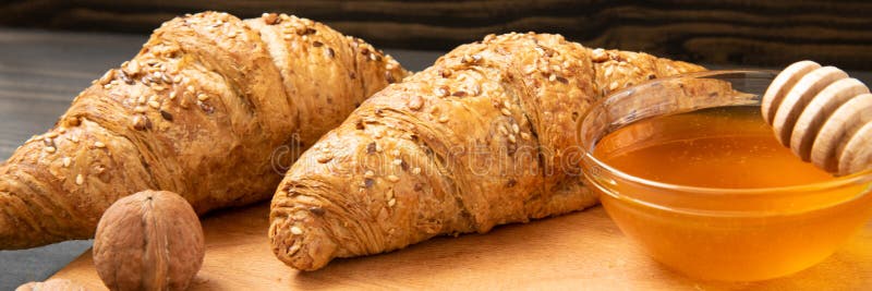 Φρέσκα croissants με το βάζο και τα καρύδια μελιού στοκ φωτογραφίες με δικαίωμα ελεύθερης χρήσης Φρέσκα croissants με το βάζο και τα καρύδια μελιού στοκ φωτογραφίες με δικαίωμα ελεύθερης χρήσης