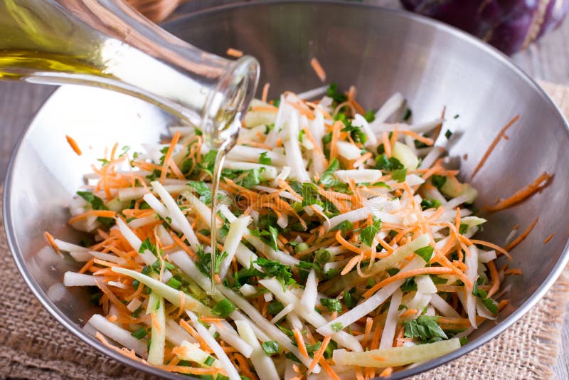 Salad of fresh vegetables. Vegetarian ingredient and olive oil for cooking healthy meal. Sliced white cabbage, paprika, cucumber, carrot. Salad of fresh vegetables. Vegetarian ingredient and olive oil for cooking healthy meal. Sliced white cabbage, paprika, cucumber, carrot