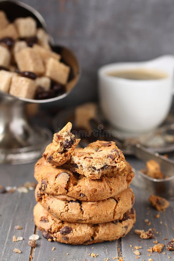 Fresh homemade chocolate chip cookies with cup of espresso on old wooden background. Fresh homemade chocolate chip cookies with cup of espresso on old wooden background.