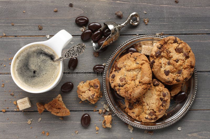 Fresh homemade chocolate chip cookies with cup of espresso on old wooden backgroundю. Fresh homemade chocolate chip cookies with cup of espresso on old wooden backgroundю