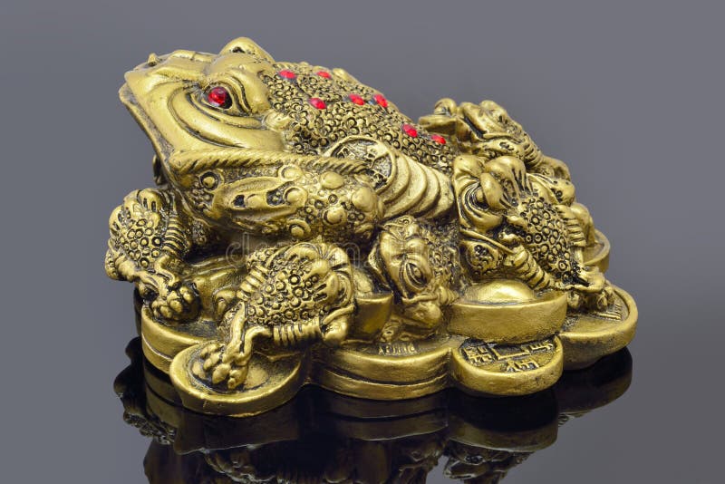 Feng Shui golden money toad sitting on mirror. Feng Shui golden money toad sitting on mirror