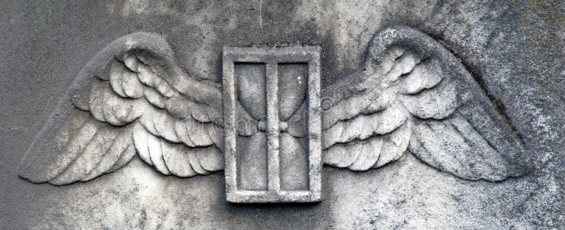 A detail from a weathered 18th century headstone. A set of wings, and hourglass and a door are carved into the granite. A beautiful element to add to a design. A detail from a weathered 18th century headstone. A set of wings, and hourglass and a door are carved into the granite. A beautiful element to add to a design.